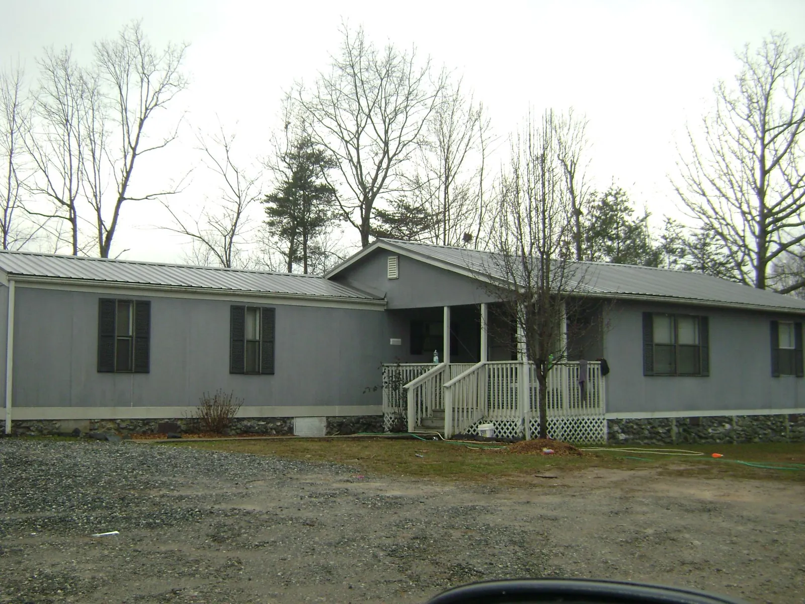 Metal roof over a manufactured home with a covered front porch in Pleasant Hill